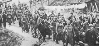 Yugoslav partisans escorting German and Swabian prisoners wither to POW camps or to trials